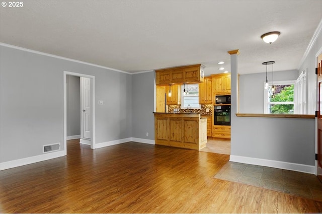 8835 NE Broadway, Portland, OR 97220 - unfurnished living room with a sink, wood finished floors, healthy amount of natural light, baseboards, and ornamental molding