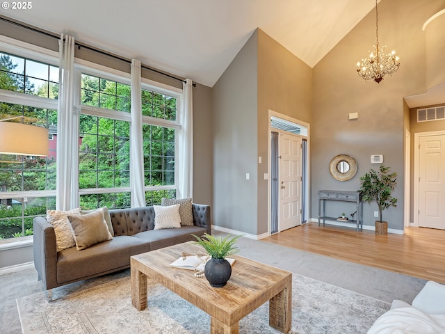1354 Skye Pkwy, West Linn, OR 97068 - living area with a chandelier, baseboards, high vaulted ceiling, and light colored carpet