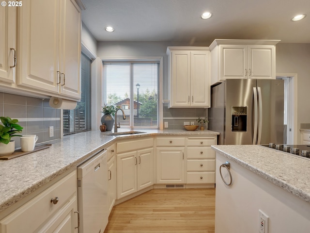 1354 Skye Pkwy, West Linn, OR 97068 - kitchen with stainless steel fridge, white dishwasher, a sink, backsplash, and recessed lighting