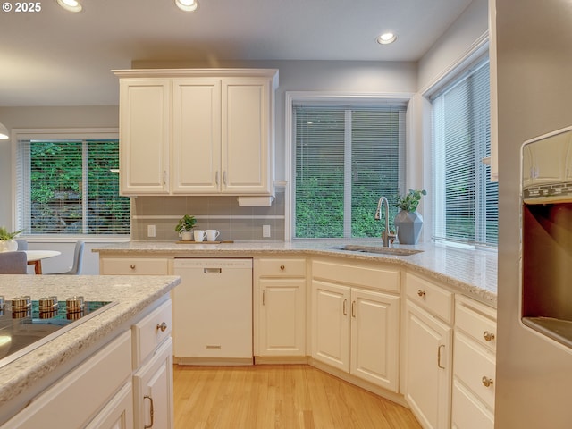 1354 Skye Pkwy, West Linn, OR 97068 - kitchen with white dishwasher, a sink, light wood-type flooring, plenty of natural light, and recessed lighting