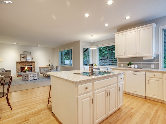 1354 Skye Pkwy, West Linn, OR 97068 - kitchen featuring dishwasher, black electric stovetop, light wood-style flooring, recessed lighting, and a kitchen island