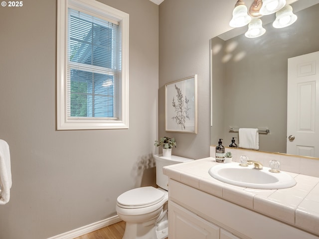 1354 Skye Pkwy, West Linn, OR 97068 - half bathroom featuring vanity, toilet, wood finished floors, baseboards, and a chandelier