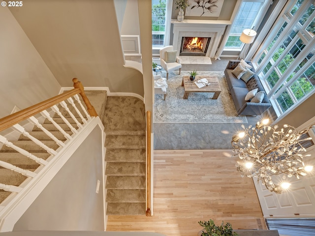 1354 Skye Pkwy, West Linn, OR 97068 - living room featuring stairway, a tiled fireplace, baseboards, and a chandelier