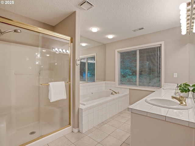 1354 Skye Pkwy, West Linn, OR 97068 - full bathroom featuring a shower stall, tile patterned floors, a garden tub, a textured ceiling, and double vanity