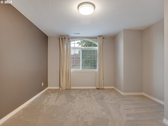 1354 Skye Pkwy, West Linn, OR 97068 - spare room featuring a textured ceiling, light colored carpet, and baseboards