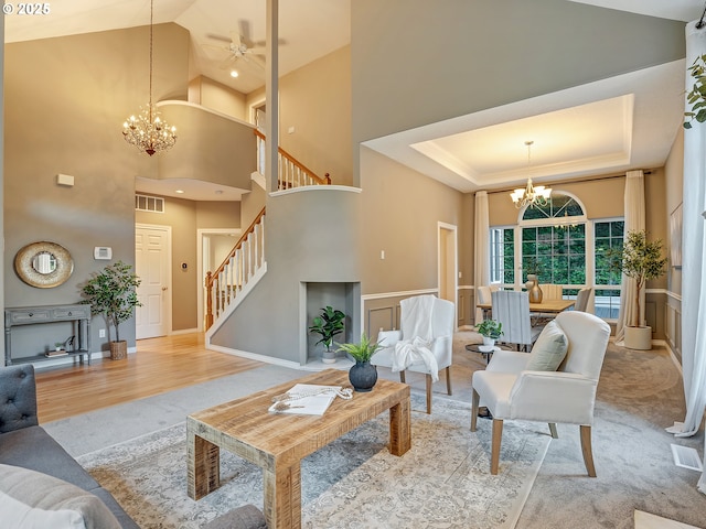 1354 Skye Pkwy, West Linn, OR 97068 - living room featuring a chandelier, stairs, high vaulted ceiling, a ceiling fan, and wood finished floors