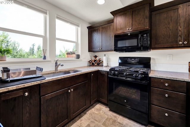 2057 S 59th St, Springfield, OR 97478 - kitchen with black appliances, dark brown cabinetry, light stone counters, and light stone finish floors