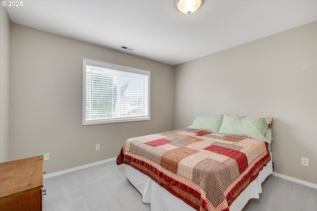 carpeted bedroom featuring baseboards and visible vents