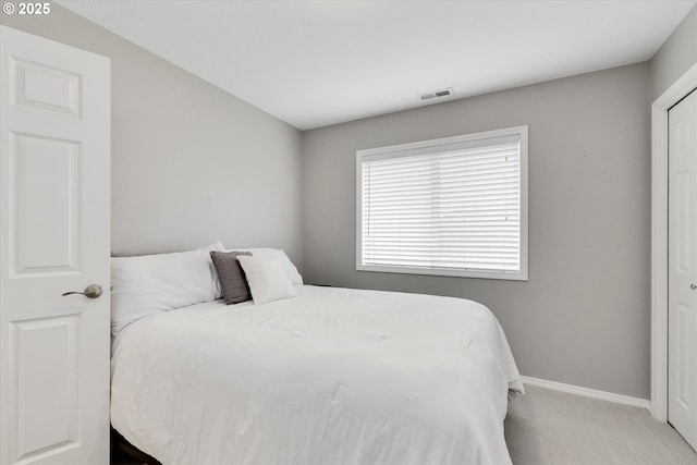 bedroom with carpet flooring, visible vents, and baseboards