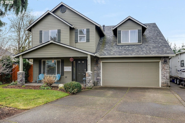 view of front facade with a shingled roof, covered porch, stone siding, driveway, and a front lawn