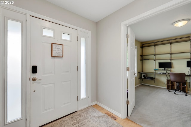 foyer with visible vents and baseboards