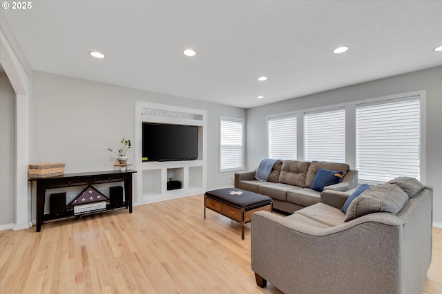 living room with recessed lighting and light wood-style flooring