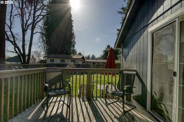 deck featuring fence and a lawn