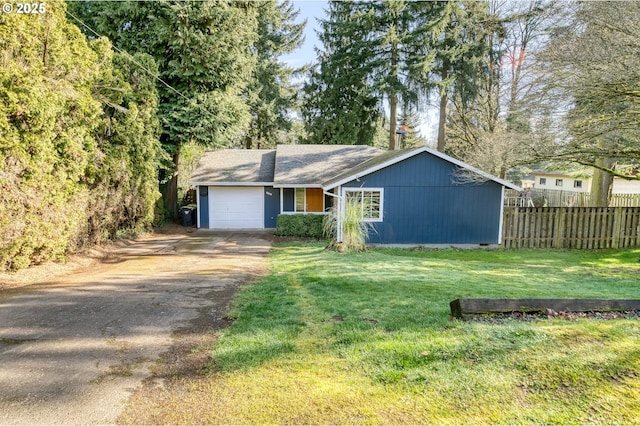 view of front of property featuring an attached garage, crawl space, fence, driveway, and a front lawn