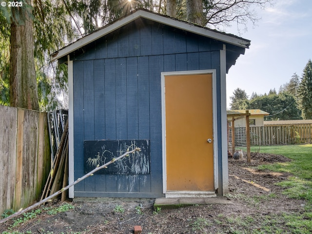 view of shed featuring fence