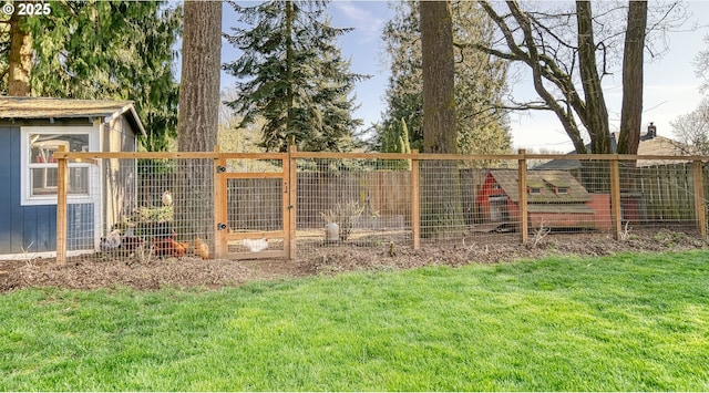 view of yard with an outbuilding and fence