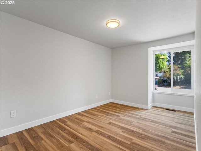 9995 SW Siuslaw Ln, Tualatin, OR 97062 - spare room featuring baseboards and wood finished floors