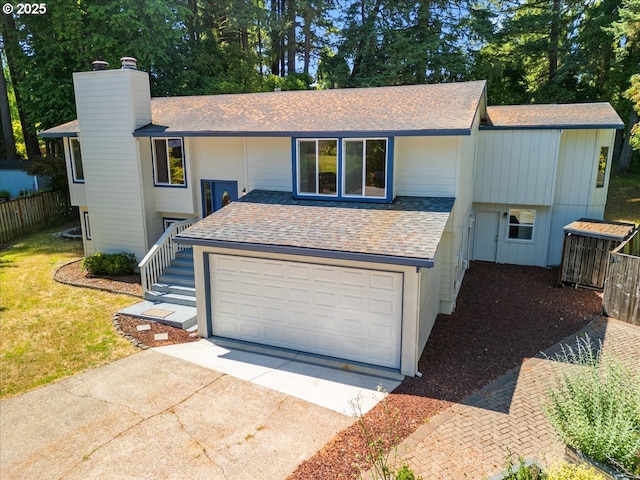 9995 SW Siuslaw Ln, Tualatin, OR 97062 - view of front facade with a chimney, concrete driveway, roof with shingles, and an attached garage