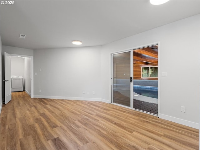 9995 SW Siuslaw Ln, Tualatin, OR 97062 - unfurnished room featuring washer / clothes dryer and light wood-type flooring