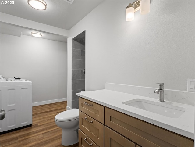 9995 SW Siuslaw Ln, Tualatin, OR 97062 - full bathroom featuring washer / dryer, vanity, wood finished floors, and a shower