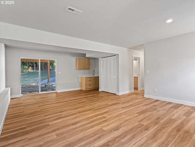 9995 SW Siuslaw Ln, Tualatin, OR 97062 - unfurnished living room featuring light wood-style flooring and recessed lighting