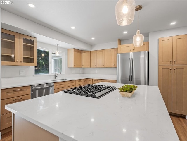 9995 SW Siuslaw Ln, Tualatin, OR 97062 - kitchen featuring stainless steel appliances, a kitchen island, light stone countertops, glass insert cabinets, and recessed lighting