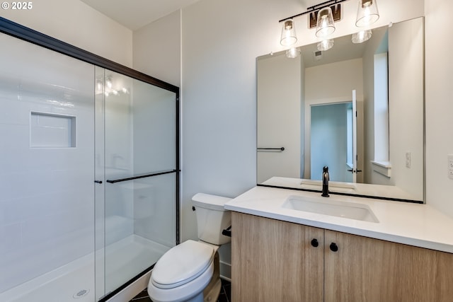 bathroom with a stall shower, visible vents, vanity, and toilet