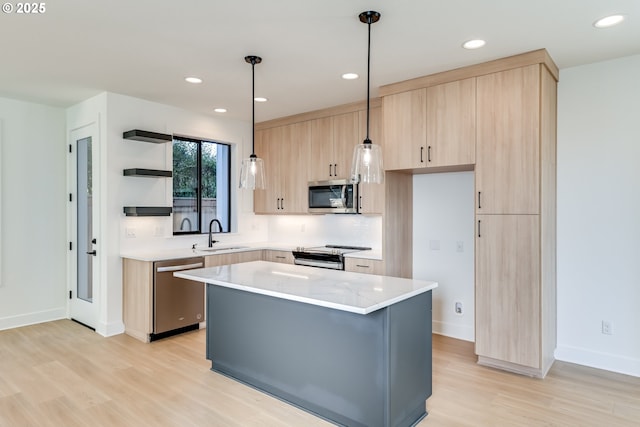 kitchen with stainless steel appliances, a sink, a center island, open shelves, and decorative light fixtures