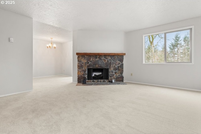 unfurnished living room featuring a stone fireplace, light colored carpet, a notable chandelier, and a textured ceiling