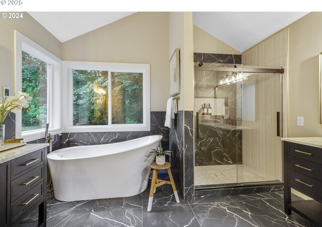 full bathroom featuring a marble finish shower, marble finish floor, and vaulted ceiling