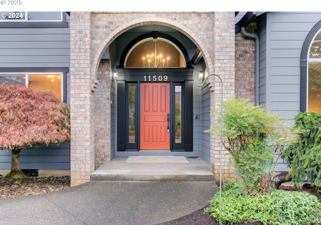 doorway to property featuring brick siding