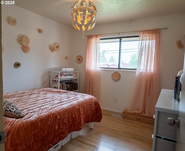 2280 NW 5th St, Gresham, OR 97030 - bedroom featuring baseboards, a chandelier, wood finished floors, and visible vents