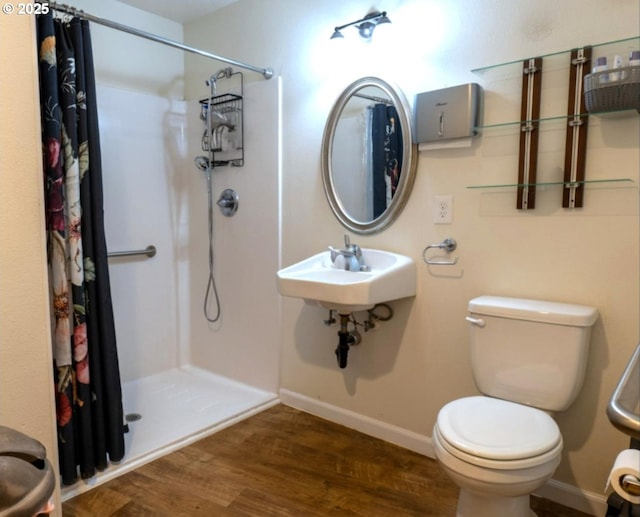 2280 NW 5th St, Gresham, OR 97030 - bathroom featuring wood finished floors, baseboards, a stall shower, and toilet