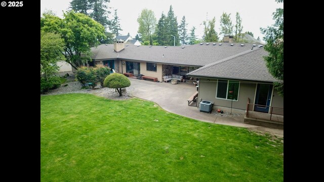 2280 NW 5th St, Gresham, OR 97030 - back of property with a chimney, roof with shingles, a patio area, central AC, and a yard