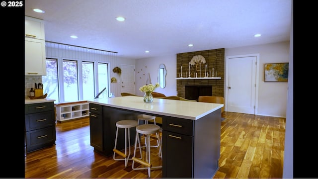 2280 NW 5th St, Gresham, OR 97030 - kitchen featuring light countertops, white cabinetry, a brick fireplace, and wood finished floors