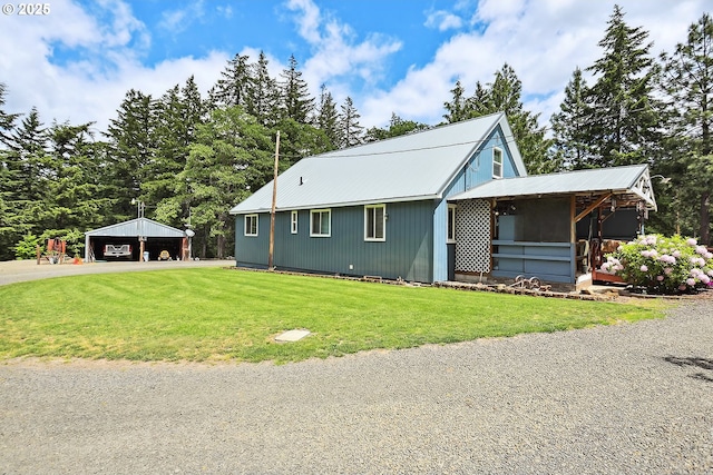 1935 Huskey Rd, Mosier, OR 97040 - view of front of house with a detached garage, a front lawn, and metal roof