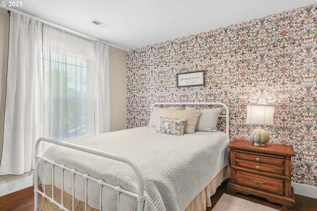 966 NW Brookhill St, Hillsboro, OR 97124 - bedroom featuring wallpapered walls, wood finished floors, and baseboards