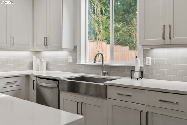 15955 SE Cherry Blossom Way, Happy Valley, OR 97015 - kitchen with dishwasher, light countertops, and backsplash