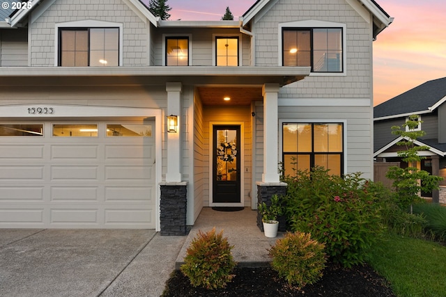 15955 SE Cherry Blossom Way, Happy Valley, OR 97015 - craftsman house featuring an attached garage, concrete driveway, and stone siding