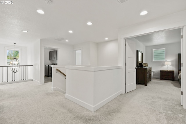 15955 SE Cherry Blossom Way, Happy Valley, OR 97015 - corridor with an upstairs landing, light colored carpet, recessed lighting, and a chandelier