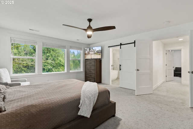 15955 SE Cherry Blossom Way, Happy Valley, OR 97015 - bedroom featuring a barn door, light carpet, a ceiling fan, and ensuite bathroom