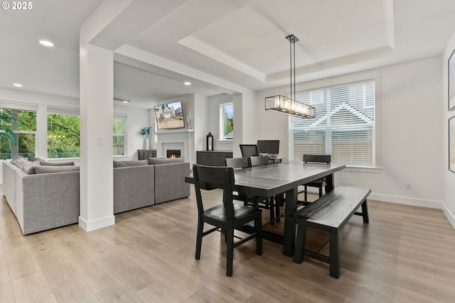 15955 SE Cherry Blossom Way, Happy Valley, OR 97015 - dining area featuring healthy amount of natural light, a tray ceiling, light wood-type flooring, recessed lighting, and ornamental molding
