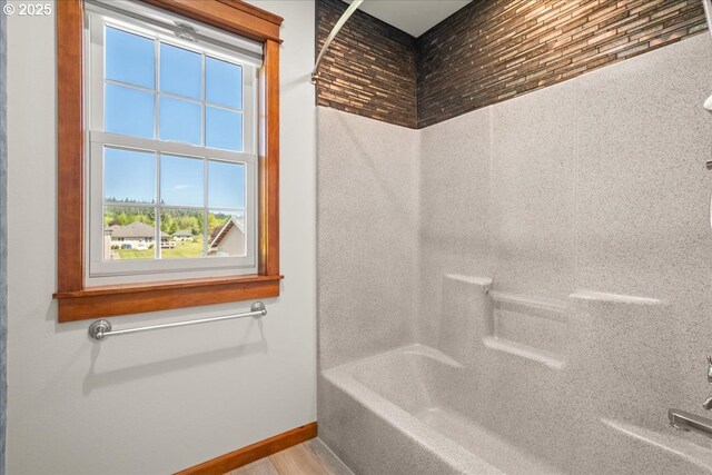 full bath featuring baseboards