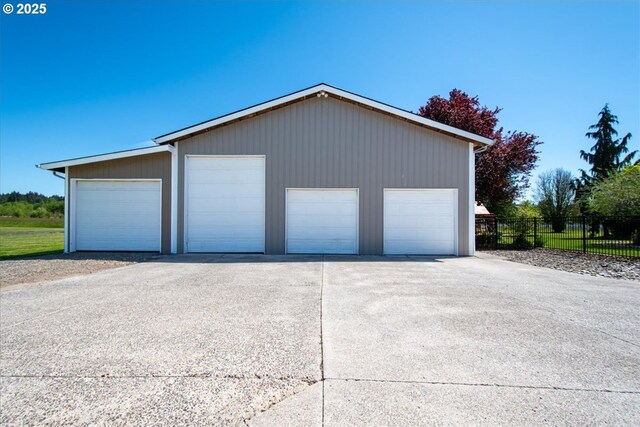 detached garage featuring fence