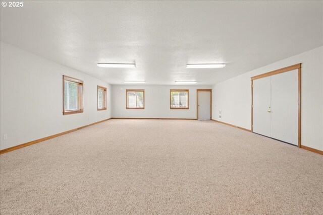 unfurnished room featuring carpet floors and baseboards