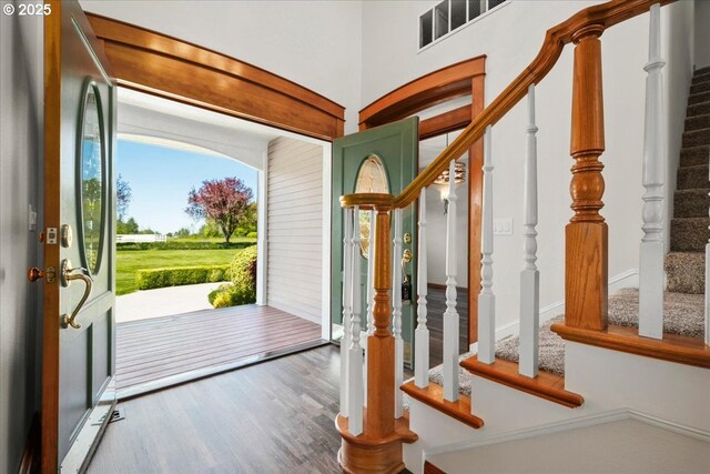 entrance foyer featuring stairs and wood finished floors