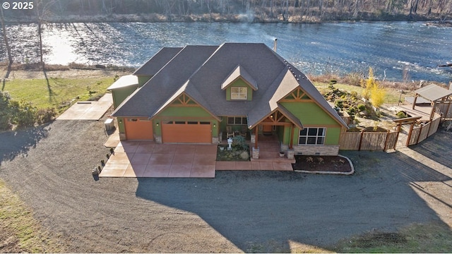 craftsman inspired home with a water view and an attached garage