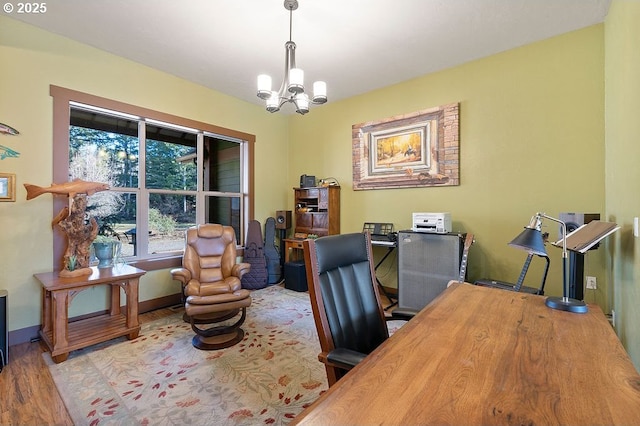 office area featuring a chandelier, wood finished floors, and baseboards