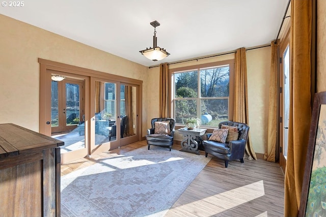 sitting room with french doors and wood finished floors
