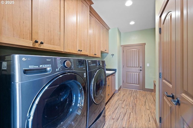 laundry room featuring washing machine and clothes dryer, cabinet space, light wood-style floors, baseboards, and recessed lighting